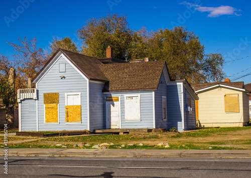 Abandoned Home With Boarded Up Doors & Windows photo
