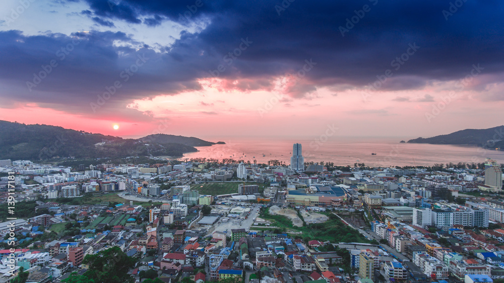 Beautiful aerial view of Patong beach over city in sunset sky.