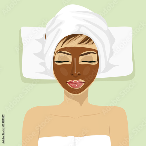 Chocolate facial mask. Chocolate therapy. Young woman with treatment mask on her face at spa salon