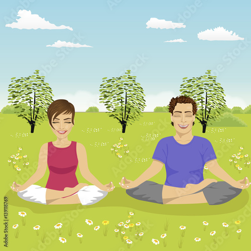 young couple doing yoga exercise in park in summer