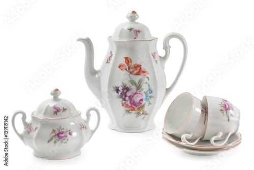 Vintage czech porcelain set for coffee, old style rich decorated by flower decors. There are coffee pot, pair of mugs, saucers, sugar-bowl, isolated on a white background.