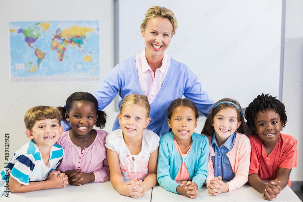 Portrait of teacher and kids in classroom