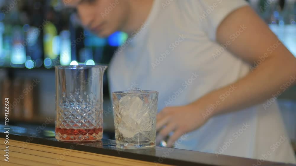Fast shooting - bartender preparing a cocktail on bar in close-up