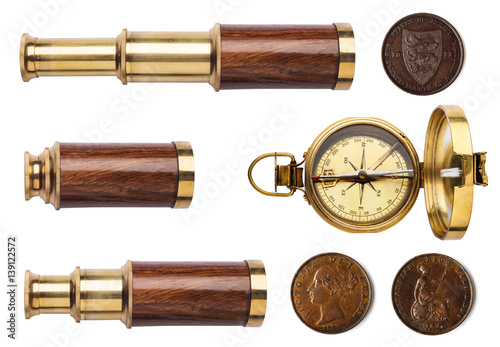 Telescope, compass, and old coins isolated on white background.