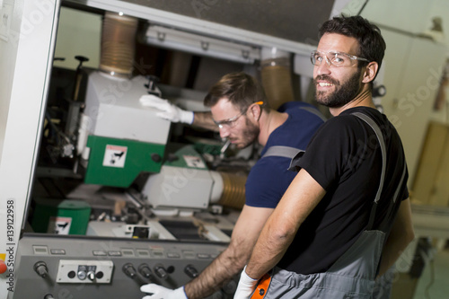 Two male workers working in furniture industry 