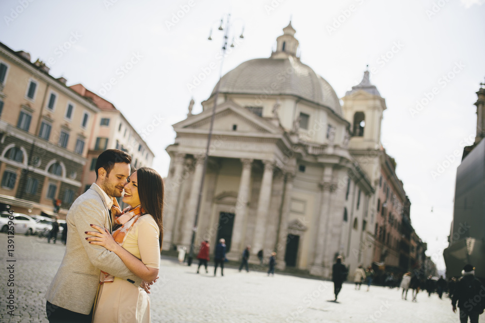 Young couple in love hugging posing in front of the Pantheon in Rome