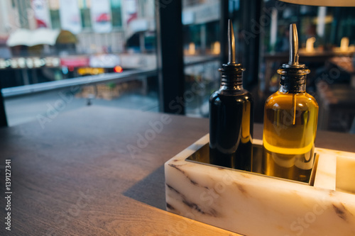 Olive oil with balsamic vinegar on a wooden table in a restaurant