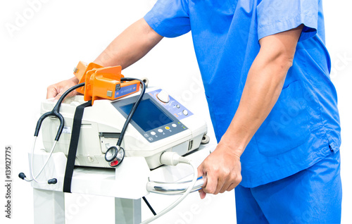 doctor hold EKG monitor and stethoscope on machine