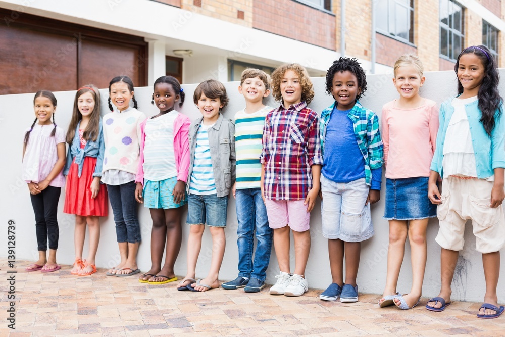 Group of kids standing in a row on school terrace Group of kids standing in a row on school terrace
