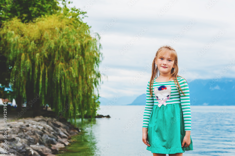 Cute little girl playing by lake Geneva, Switzerland Cute little girl playing by lake Geneva, Switzerland