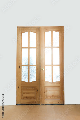 wooden double-leaf door on a light background