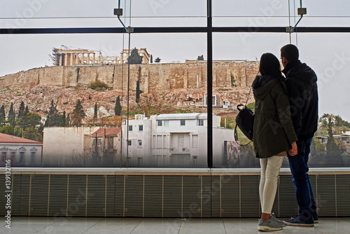 Young couple seeing the Acropolis in Athens.