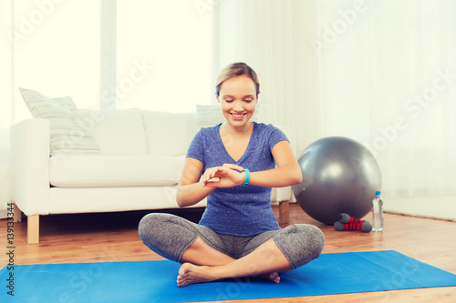 happy woman with heart-rate watch exercising