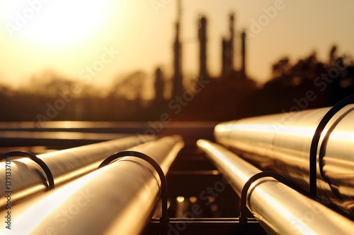 golden sunset in crude oil refinery with pipeline system photo