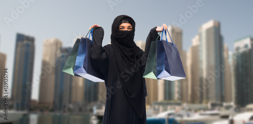 muslim woman in hijab with shopping bags in dubai
