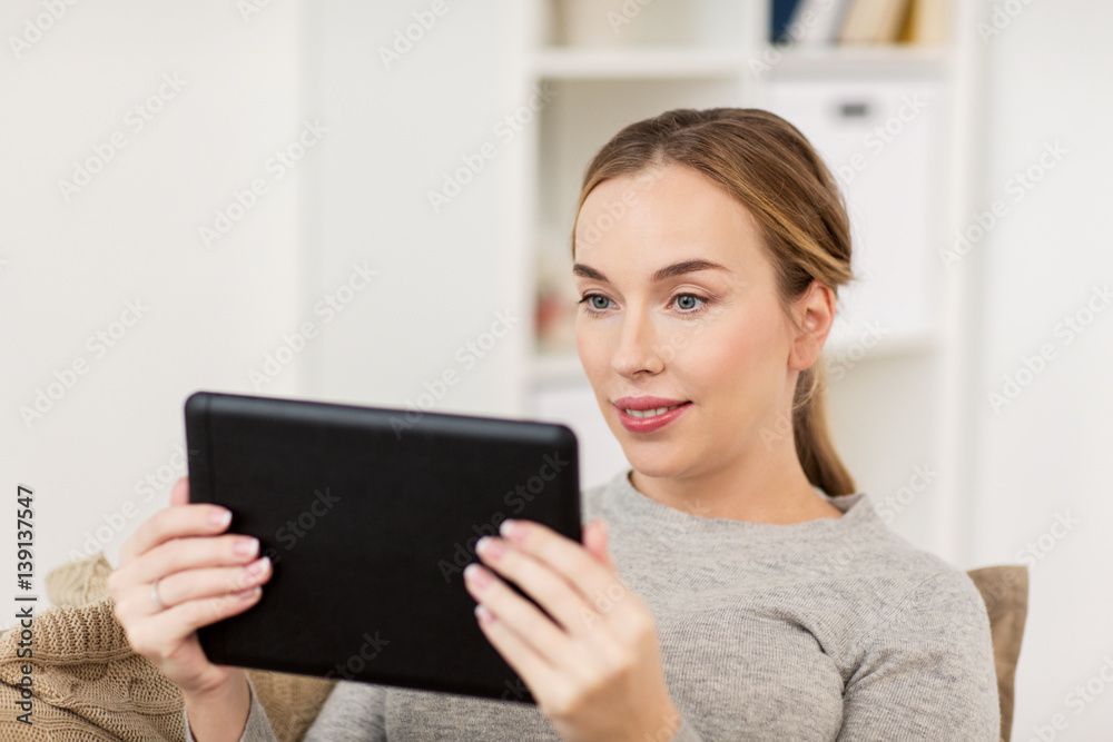 smiling woman with tablet pc at home smiling woman with tablet pc at home