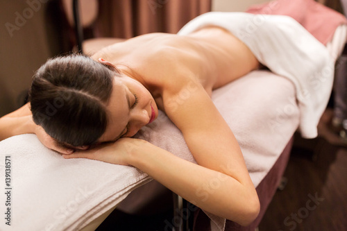 young woman lying at spa or massage parlor
