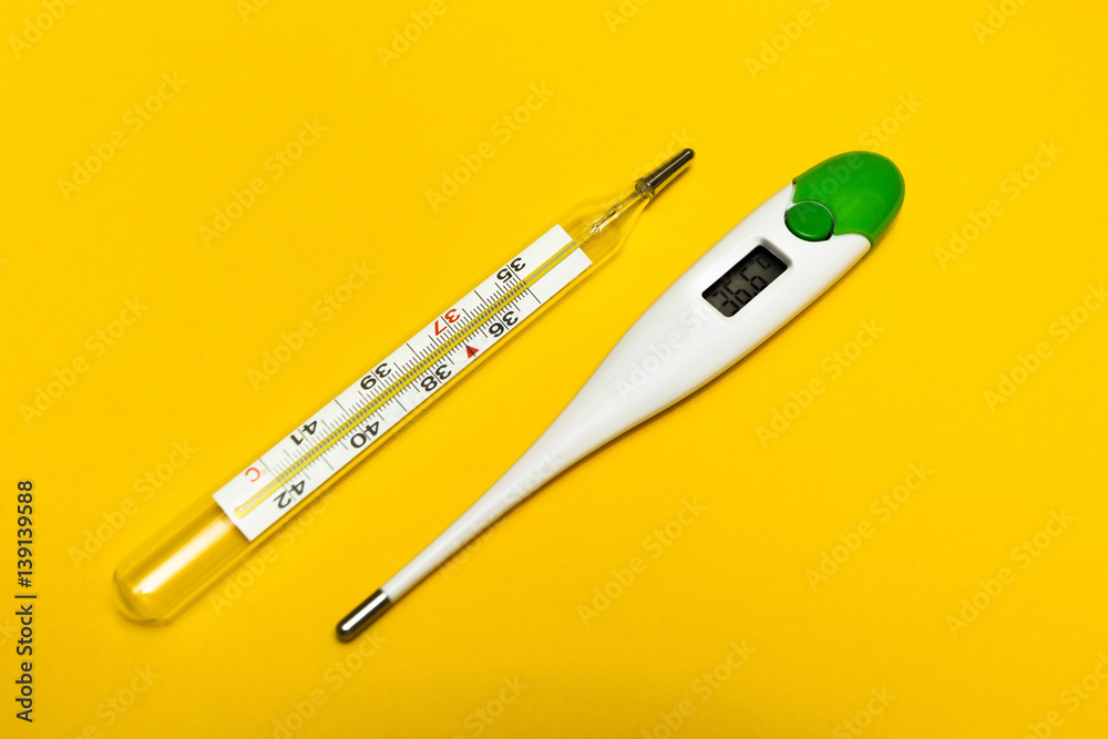 Analog and digital thermometer on a yellow background. The temperature of 36.6 C. Analog and digital thermometer on a yellow background. The temperature of 36.6 C.
