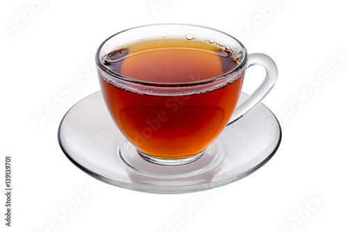 Transparent glass cup of tea and a saucer isolated on white background