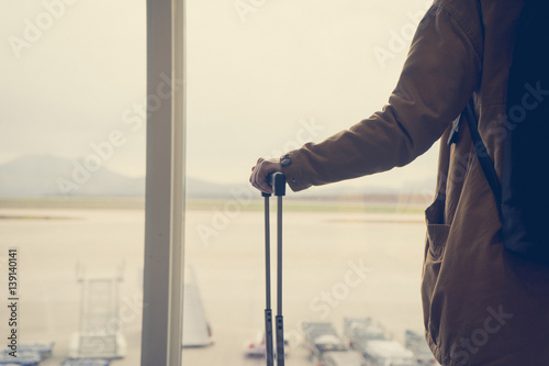Girl holding suitcase in the airport © SianStock