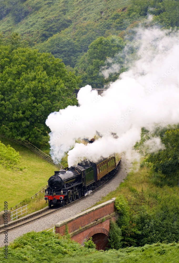 Obraz premium Heritage Rail Steam Engine in full steam