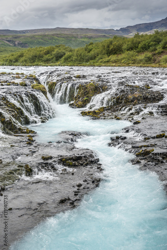 Bruarfoss cascade waterfall with blue water. Iceland