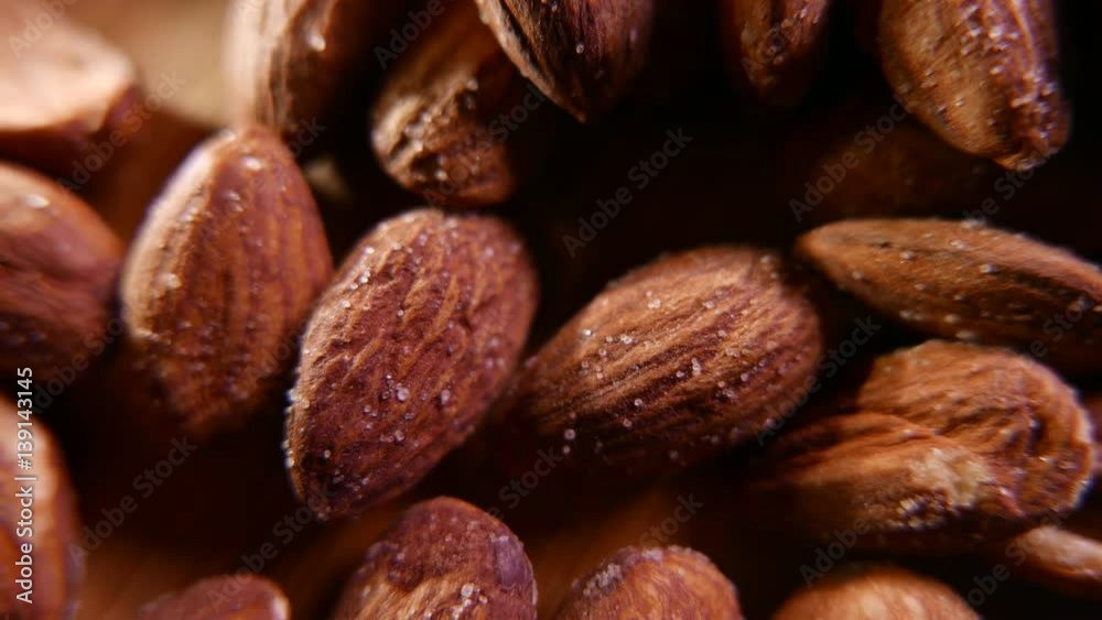 Almonds and sweets on a wooden background. Closeup 4K UHD Almonds and sweets on a wooden background. Closeup 4K UHD