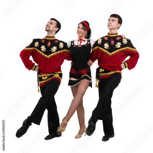 two men and one woman wearing a folk russian costume posing