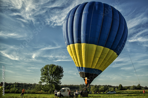 Start of big hot air balloons at the field with cool cloudy sky