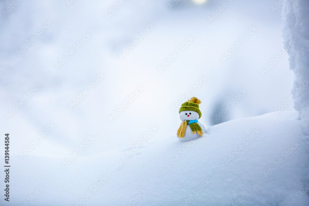 Naklejka premium Dreaming snowman in green hat.