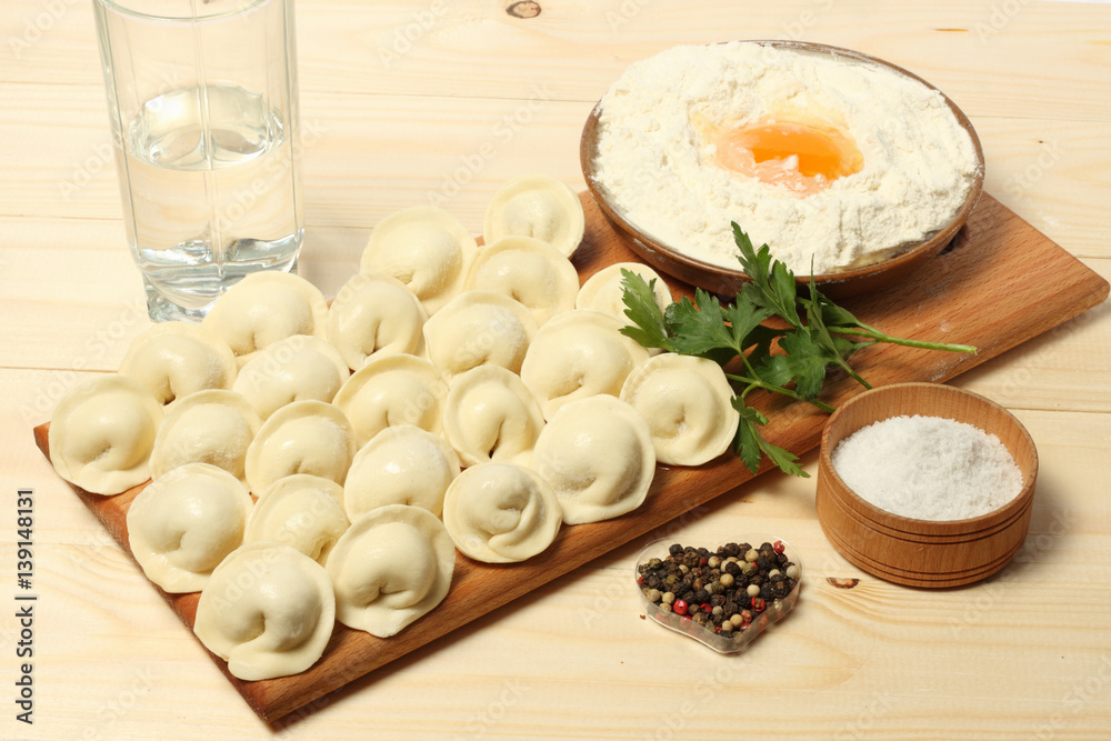 raw russian pelmeni on wood background raw russian pelmeni on wood background