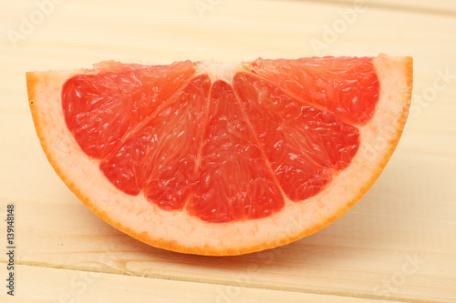 pieces of grapefruit on wood on white