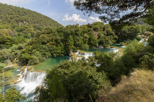 Scenic view of waterfalls, cascades and lush foliage at the Krka National Park in Croatia. Viewed slightly from above.