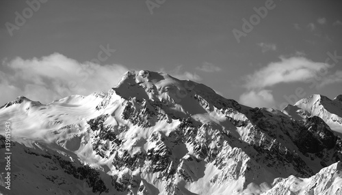 Black and white view on snowy mountains at sun day