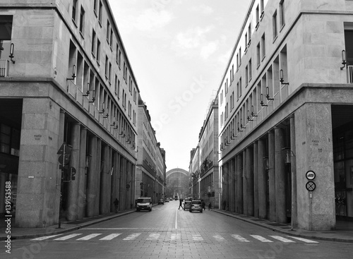 Via Roma seen from CNL Square with Porta Nuova Station in the background in Torino, Italy. These street was built during the Fascist era and it’s an example of Italian Rationalism. Black and white.