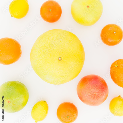Citrus fruits - lemon, orange, grapefruit, sweetie and pomelo on white background. Flat lay, top view. Fruit's background