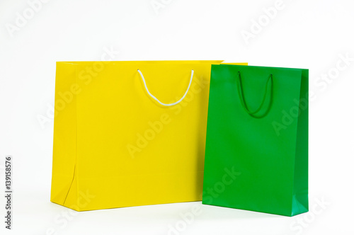 Yellow and green paper bag on a white background.