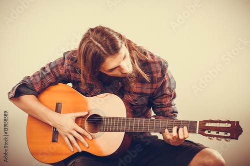 Guitarist is playing the guitar.