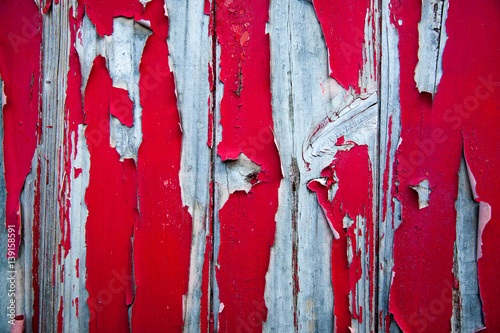 Peeling red paint on silvered wood