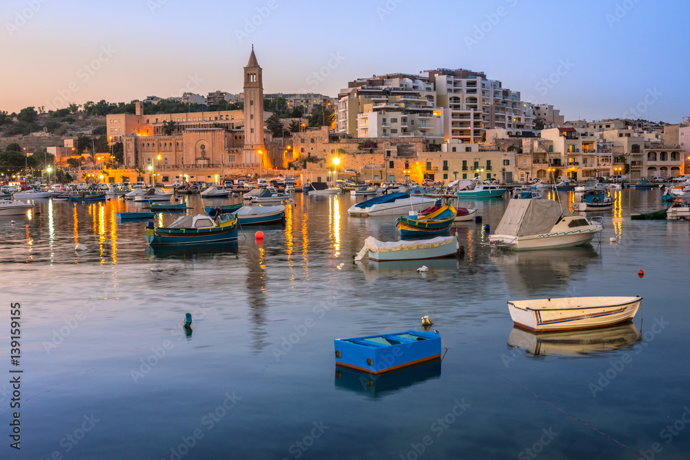 Fisherman and passenger boats in Marsaskala bay in Malta