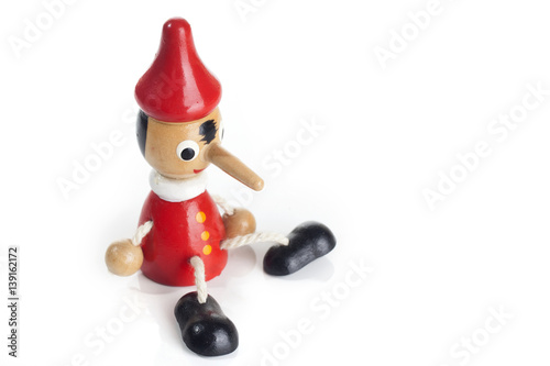 Wooden Pinocchio doll isolated on white background.