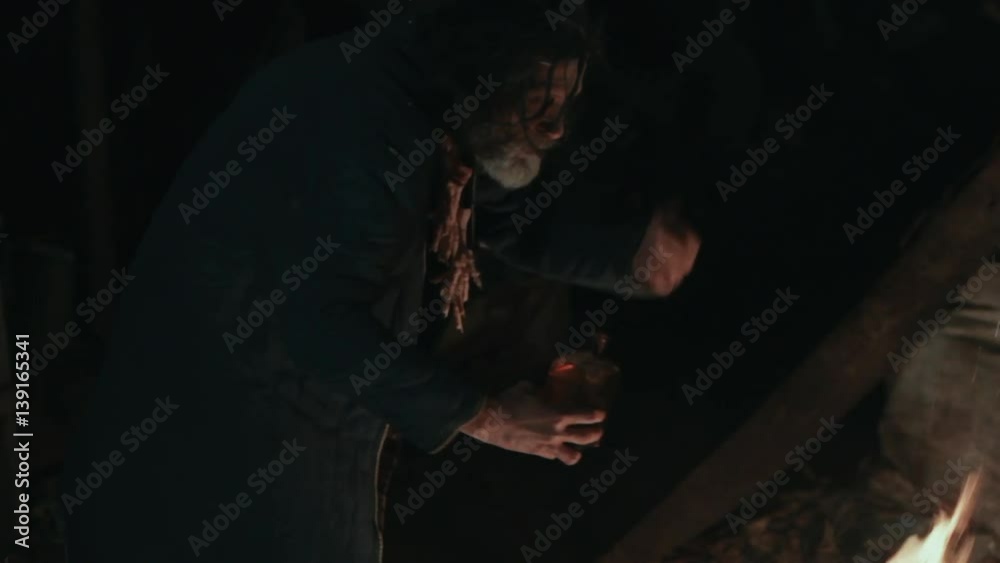 The old shaman dances around the fire The old shaman dances around the fire
