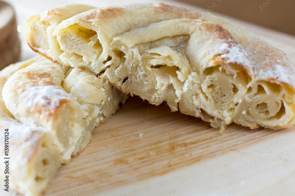 Fresh and delicious cheese pie cut on the wooden plate Fresh and delicious cheese pie cut on the wooden plate