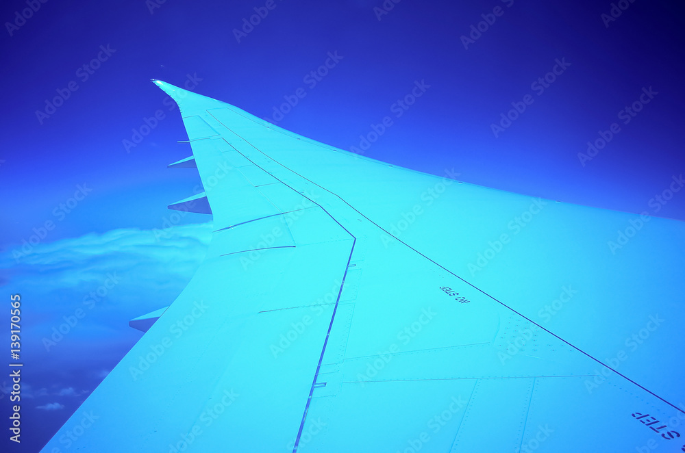 Aerial view of airplane wing in sky Aerial view of airplane wing in sky