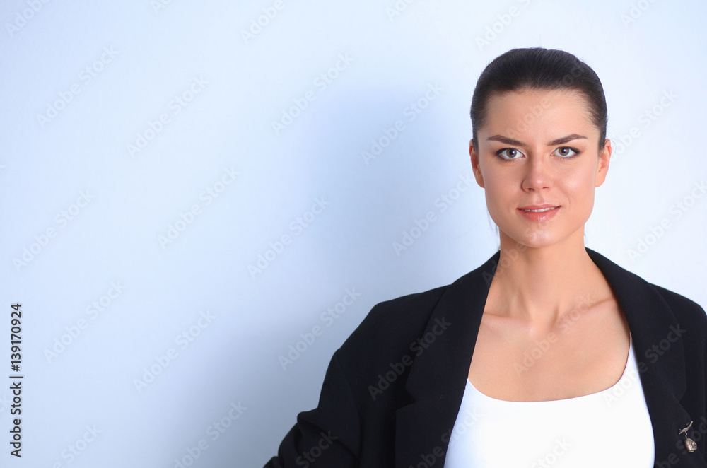Young woman standing, isolated on gray background Young woman standing, isolated on gray background