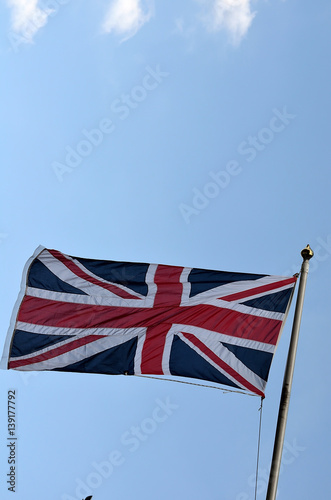 Flag of United Kingdom is Flying in sky.