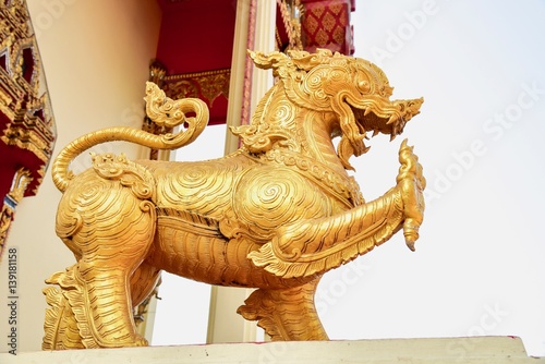 Golden Singha Sculpture at the Entrance to a Buddhist Temple