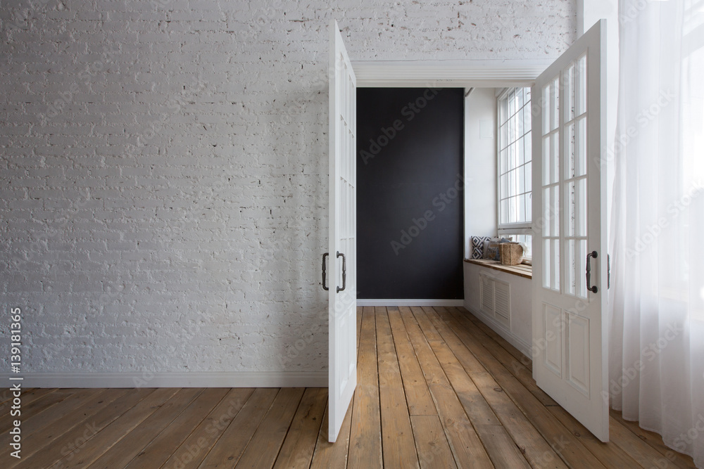 Opened white doors in empty room Opened white doors in empty room