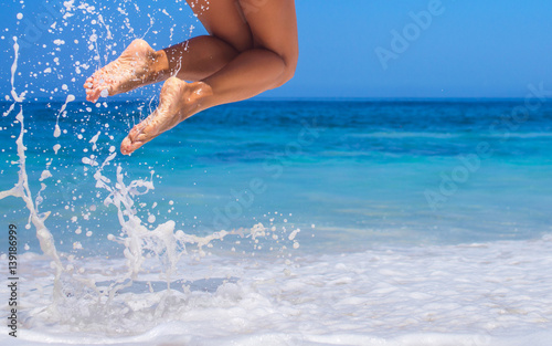 woman legs  jumping on the beach