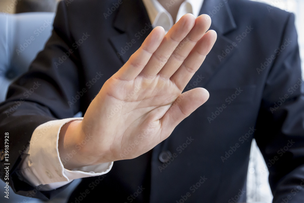 Businessman hand showing stop sign